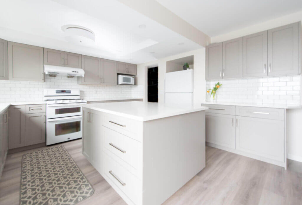 A newly remodeled kitchen with new cabinets, countertops, and cupboards done by a general contractor.