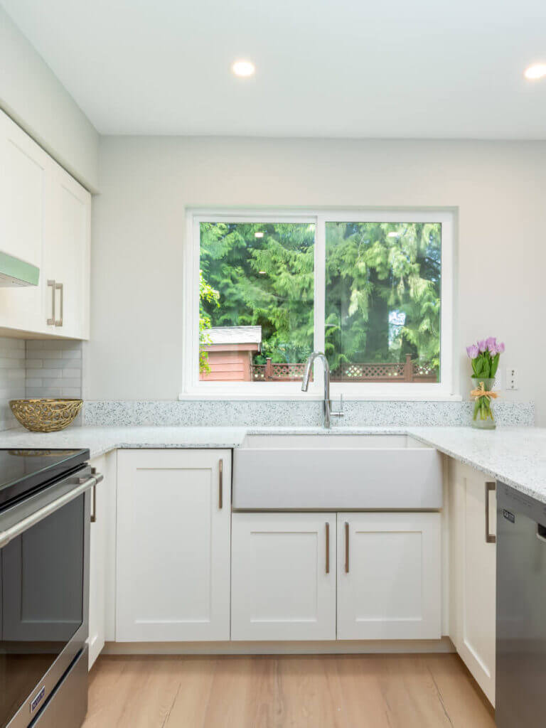 Newly renovated kitchen with new appliances, lighting, cupboards, and flooring.