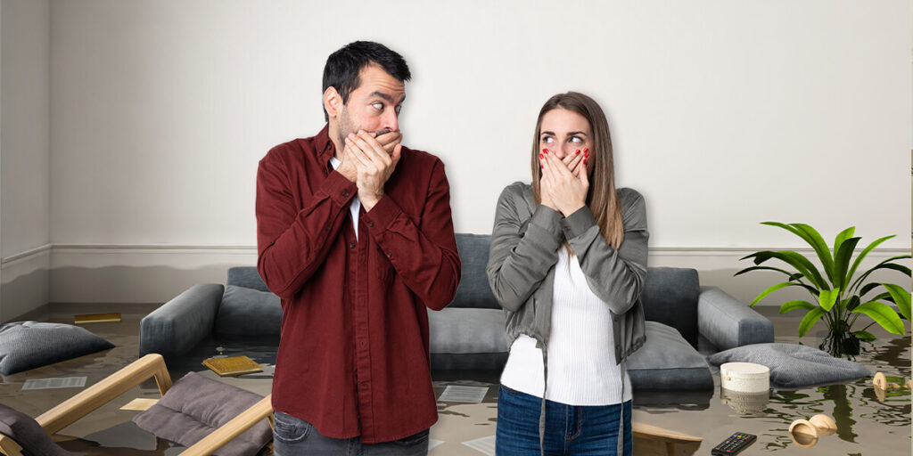 A couple gasping at their bad home renovation in the living room.